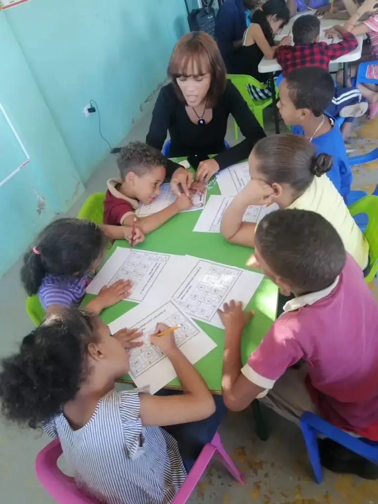 Children collaborating on a group activity at a classroom table.