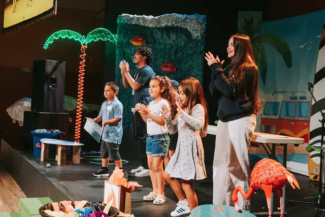 Christian Life Fellowship Cape Coral FL kids worshipping on stage during Sunday school