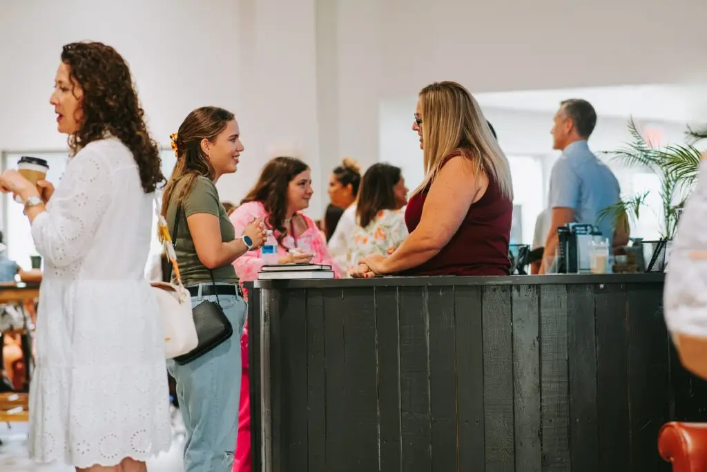 Group discussing at a counter, smiling together.