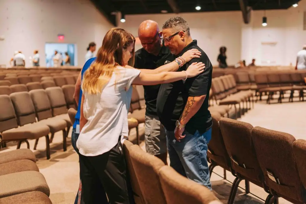People praying together at church in Cape Coral